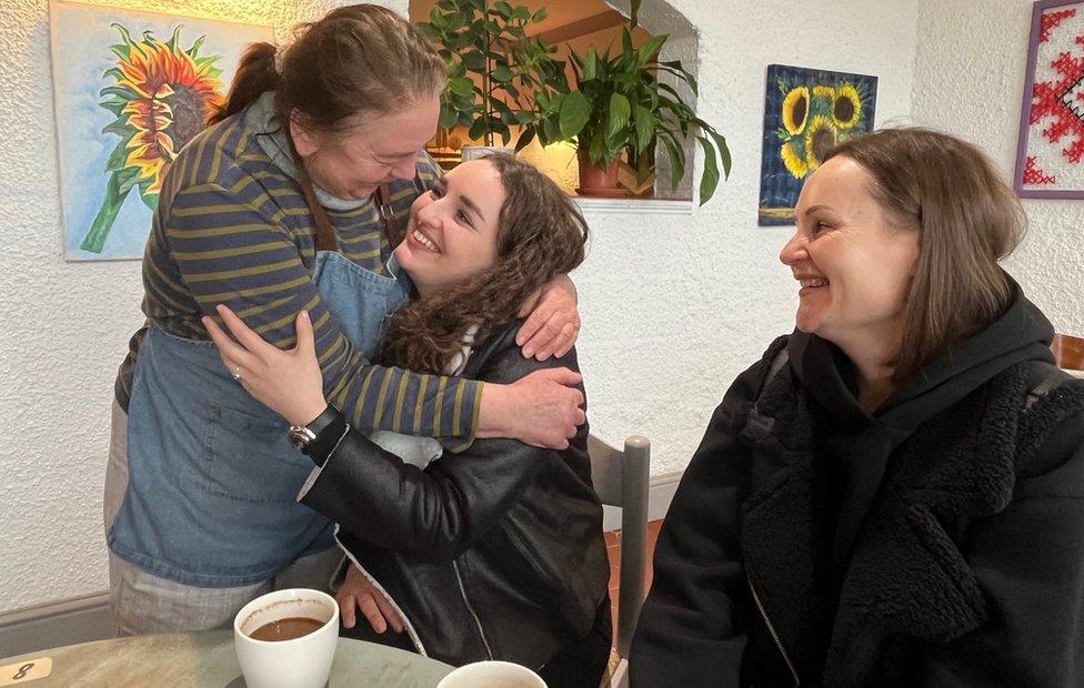 Lena Sutherland, left, comforts Hanna Nakonechna as mum Svitlana looks on