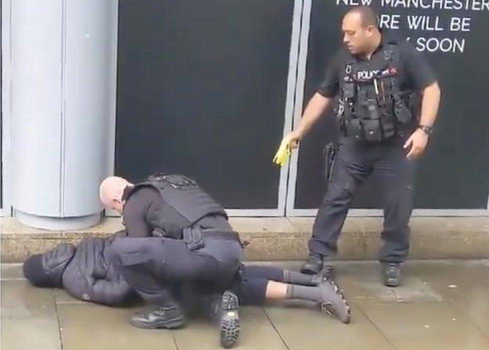 Officers with an arrested man