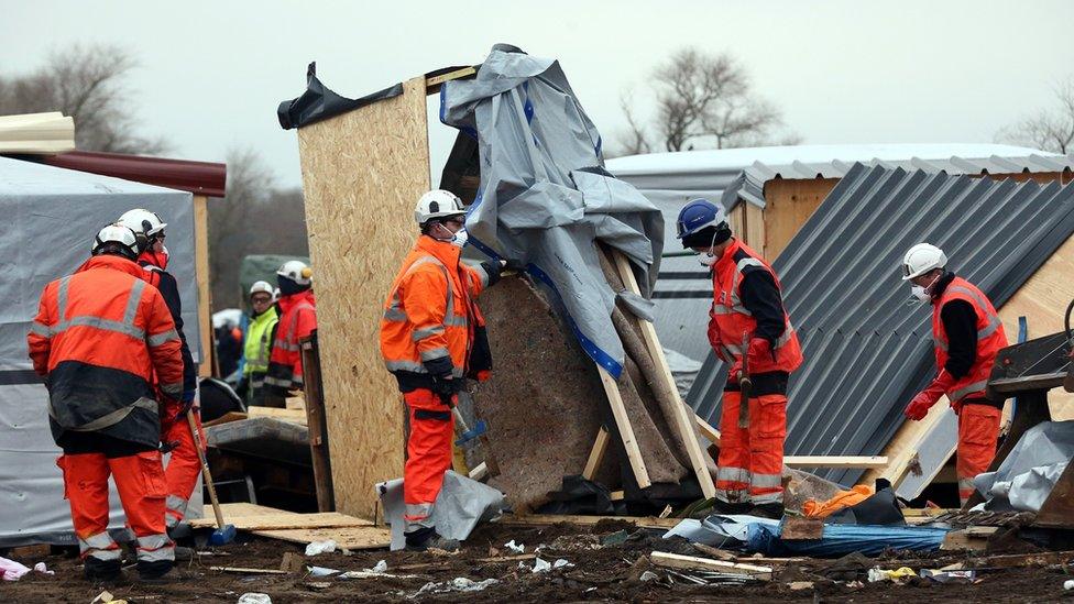 Demolition workers destroy huts as they clear part of the 'jungle' migrant camp on March 01, 2016 in Calais, France. Police and demolition teams are continuing to dismantle makeshift shelters in the migrant camp known as the 'Jungle' and relocating many people to purpose-built accommodation nearby.