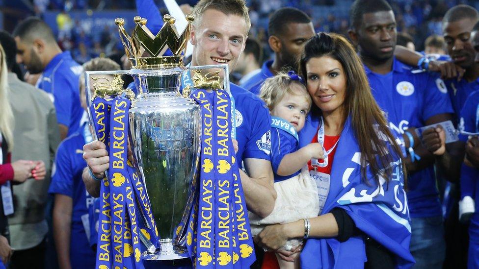 Jamie Vardy lifts the trophy as he celebrates winning the Barclays Premier League as partner Rebekah Nicholson looks on