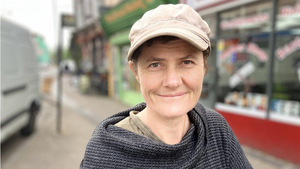 Nicola Strange, wearing a hat, standing on the street in St Paul's