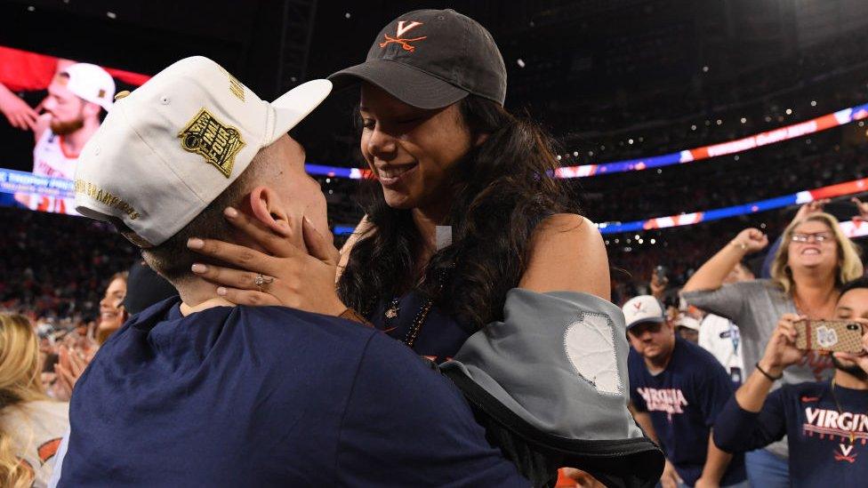 Kyle Guy embraces his fiancée Alexa Jenkins after the game