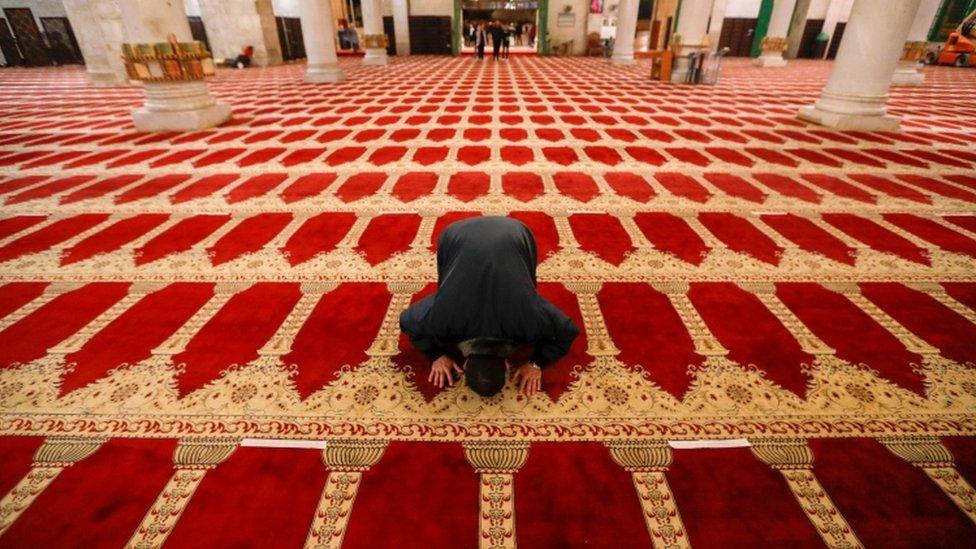 A Palestinian man performs the morning prayer inside the Al-Aqsa mosque