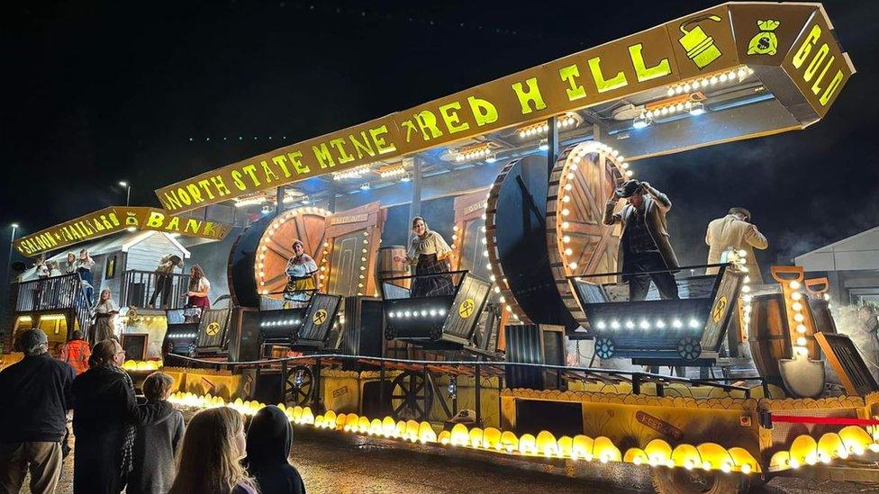 A large carnival float with flashing lights