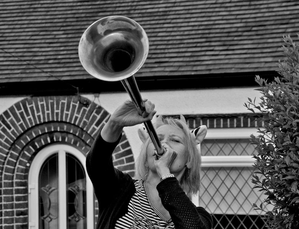 Woman blowing a horn