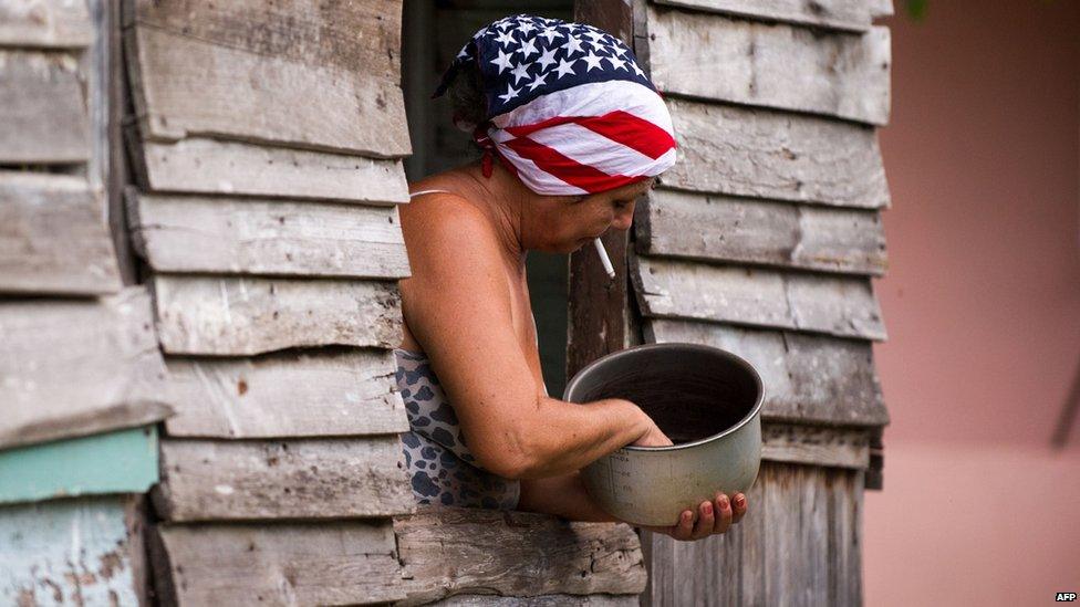 A woman wearing a headscarf with a US flag design works at her house in Havana on 1 July, 2015