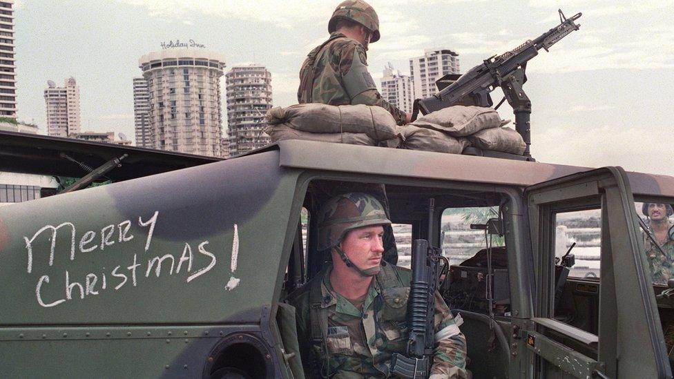 US soldiers man their security position outside the Vatican embassy in Panama City where Panamanian General Manuel Noriega was seeking asylum on 25 December. 1989.