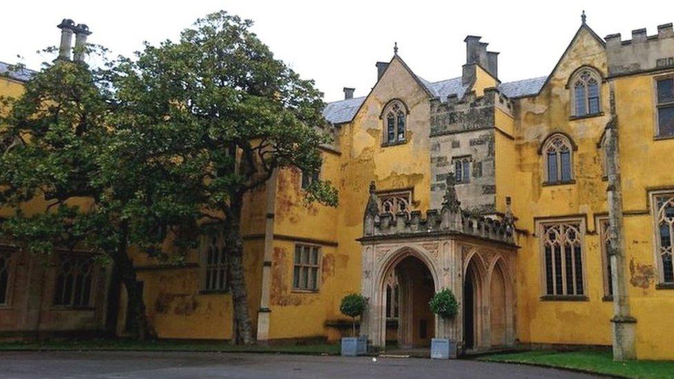 The main entrance to Ashton Court Mansion, with trees either side