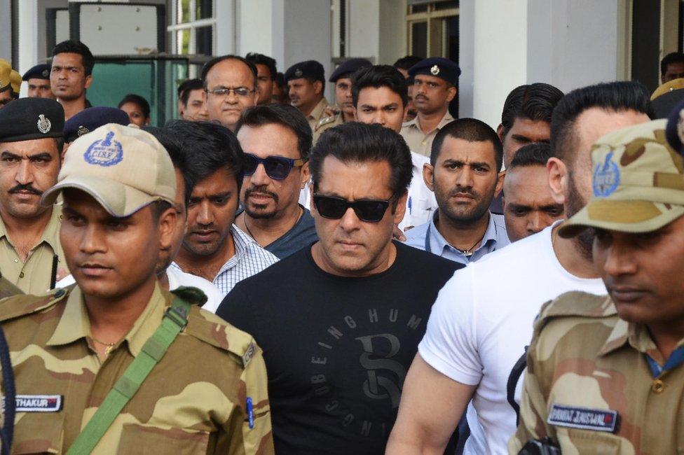 Salman Khan (C) arrives at the airport in Jodhpur ahead of a verdict