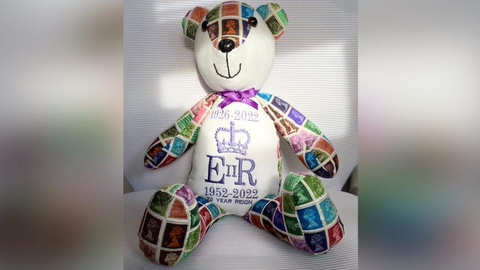 A teddy made by Sharon Samways marked with Royal cyphers and images of stamps