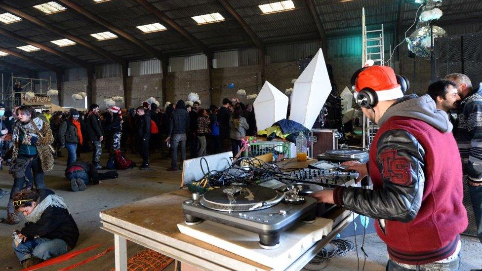 Revellers at a rave in a warehouse in Brittany