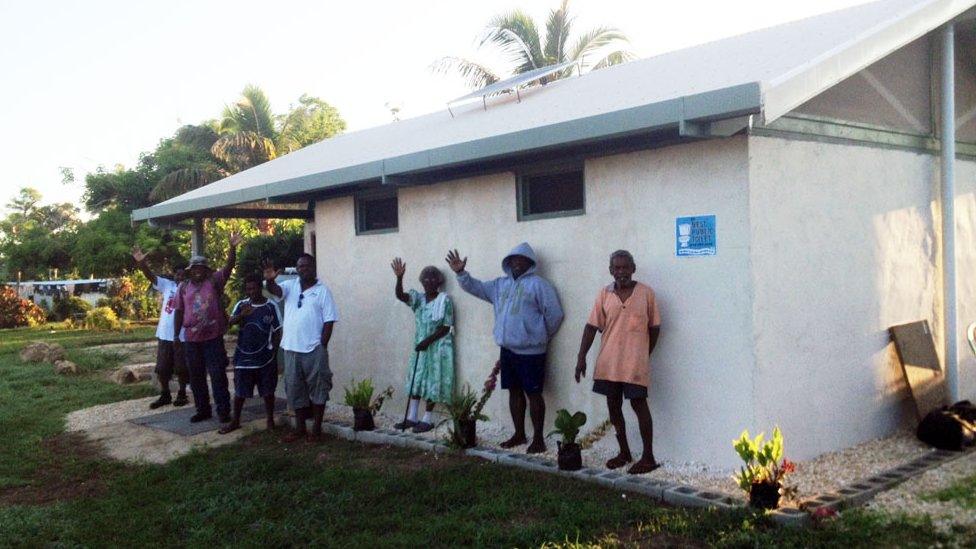 Residents of Paunangisu in front of their public toilet