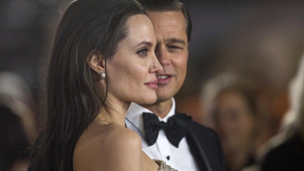 Director and cast member Angelina Jolie and her husband and co-star Brad Pitt pose at the premiere of "By the Sea" during the opening night of AFI FEST 2015 in Hollywood, California November 5, 2015