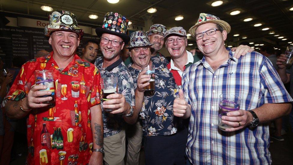 Friends pose during the traditional hat day during the CAMRA Great British Beer Festival at Olympia in London