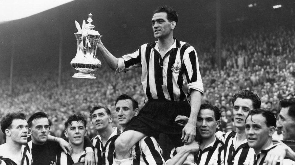 Team-mates lift Newcastle United captain Joe Harvey on their shoulders as they celebrate the FA Cup final win