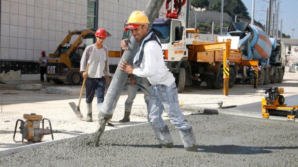 Concrete being poured by a builder