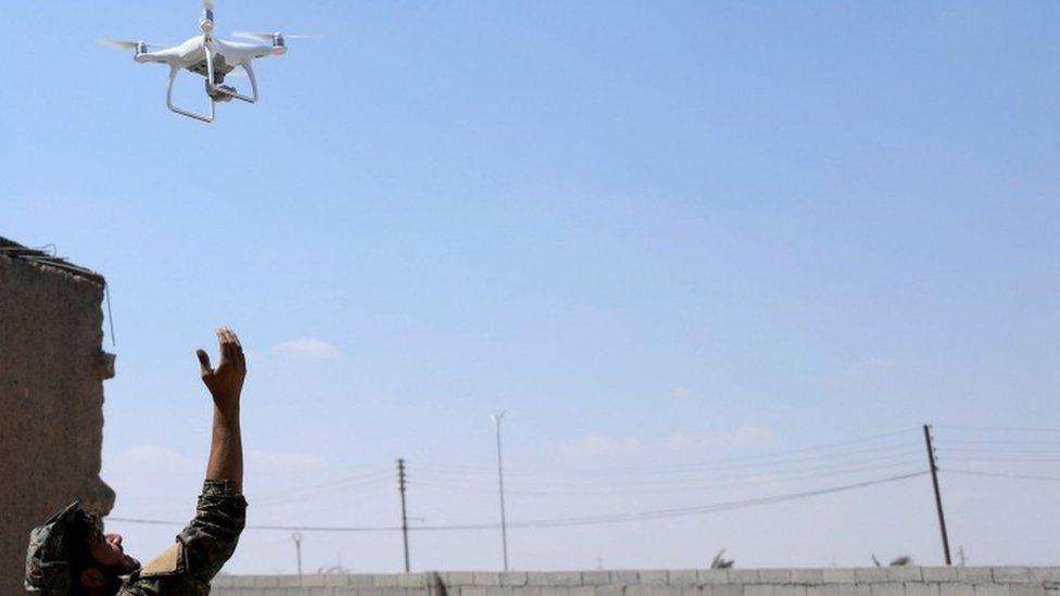 A Syrian Democratic Forces soldier releases a drone, 18 June