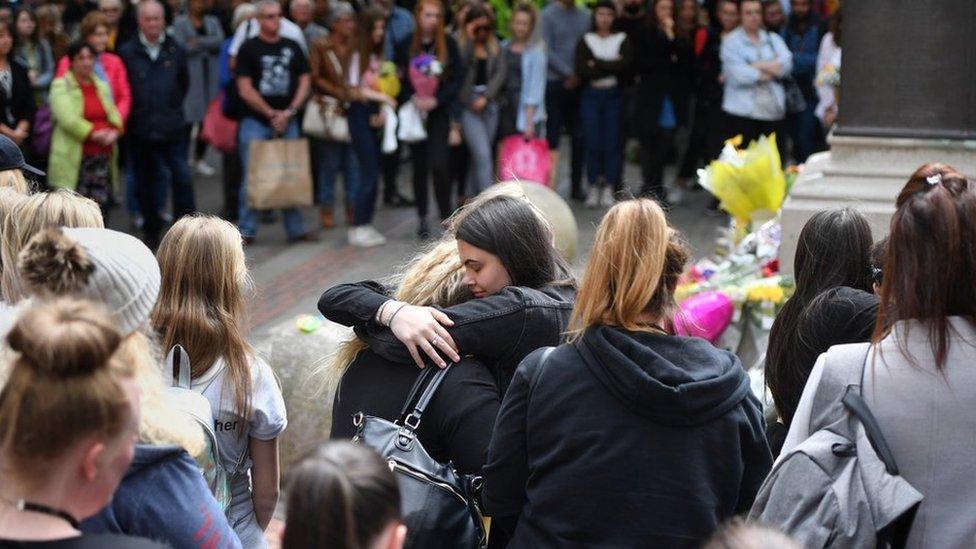 Two women hug during minute's silence