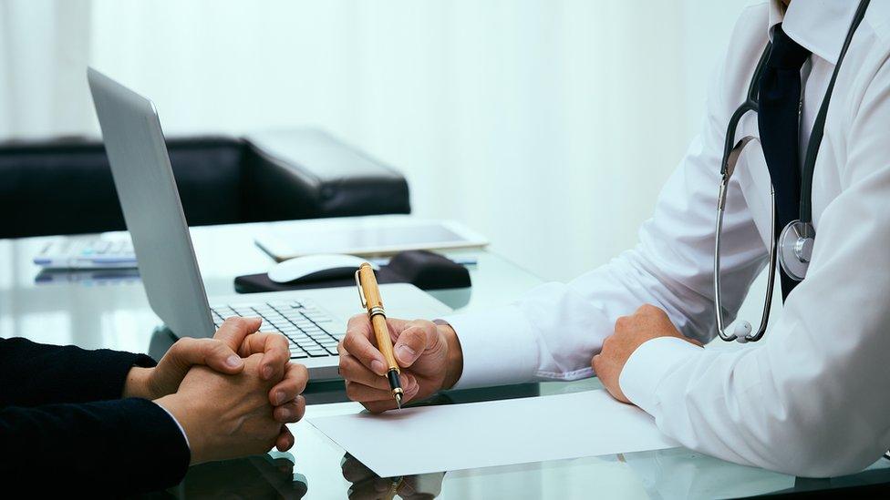 A GP speaking to a patient