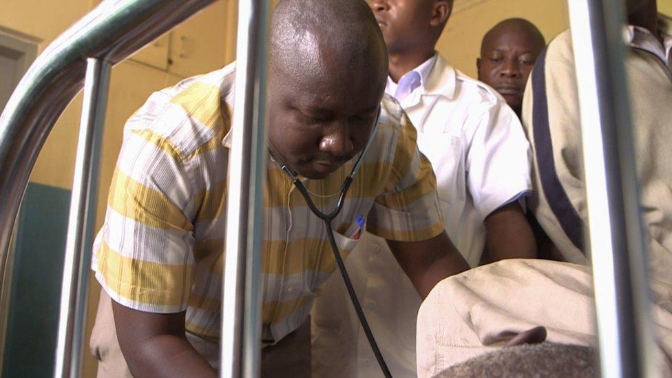 Dr Charles Waako treats a patient