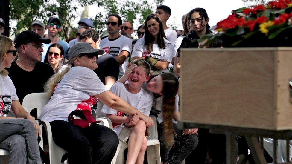 Gali Idan comforts her son at Maayan's funeral