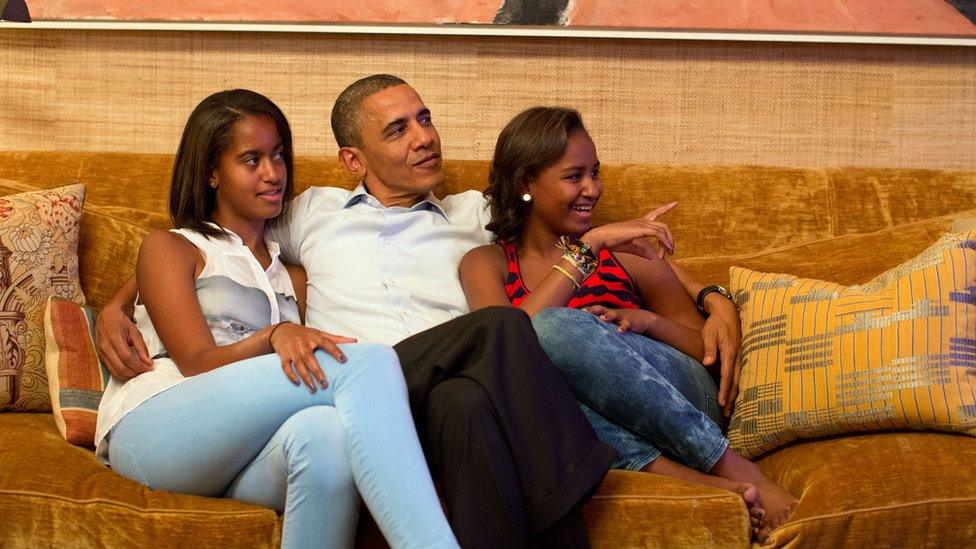 President Barack Obama and his daughters, Malia (left) and Sasha, watch on television in the Treaty Room of the White House