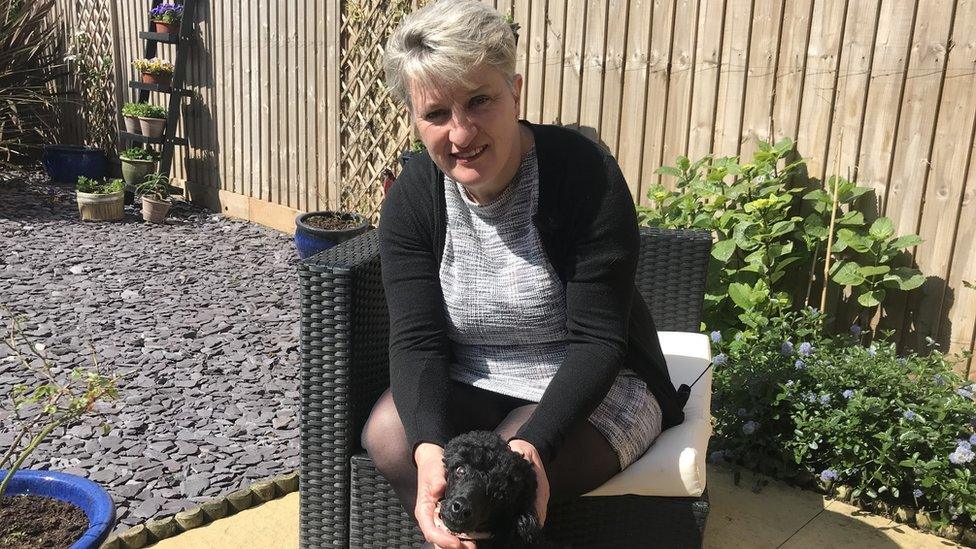 Dr Joselyn Sellen in her garden with her dog