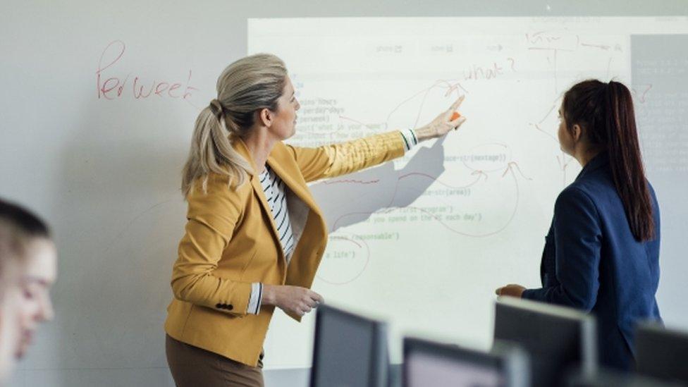 Teacher pointing at whiteboard