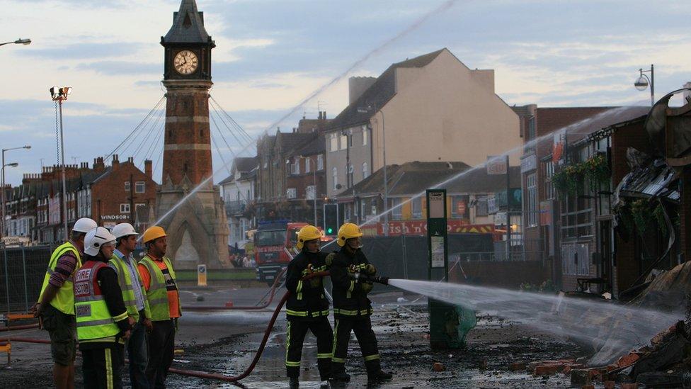 Firefighters damping down