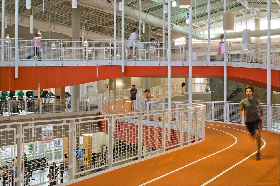 Students running round a race track at a gym at Auburn University in Alabama, USA