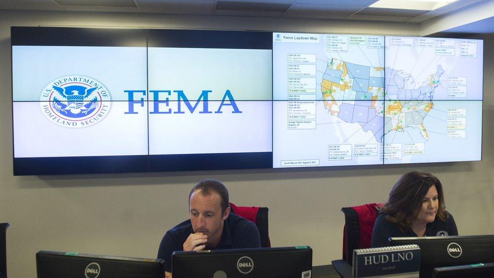 Employees work on computers inside the FEMA Command Center at in Washington, DC, August 4, 2017