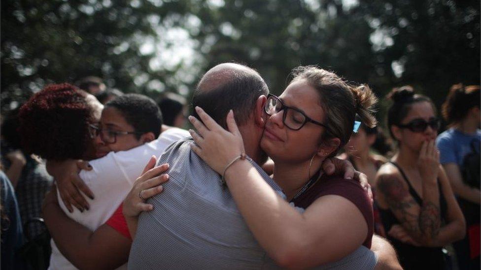 Employees of Brazil's National Museum console each other after the devastating fire which gutted the building on 2 September 2018