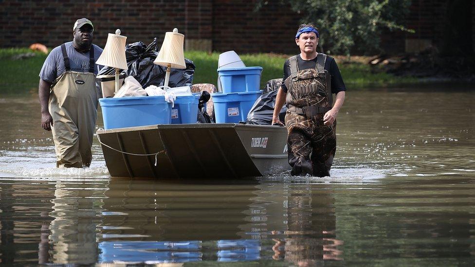 two men rescue contents of house from flood