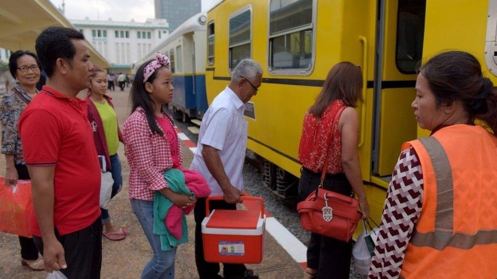 Cambodian passengers board a train at the Phnom Penh train station on April 30, 2016, as the railway service resumes after years of suspension.