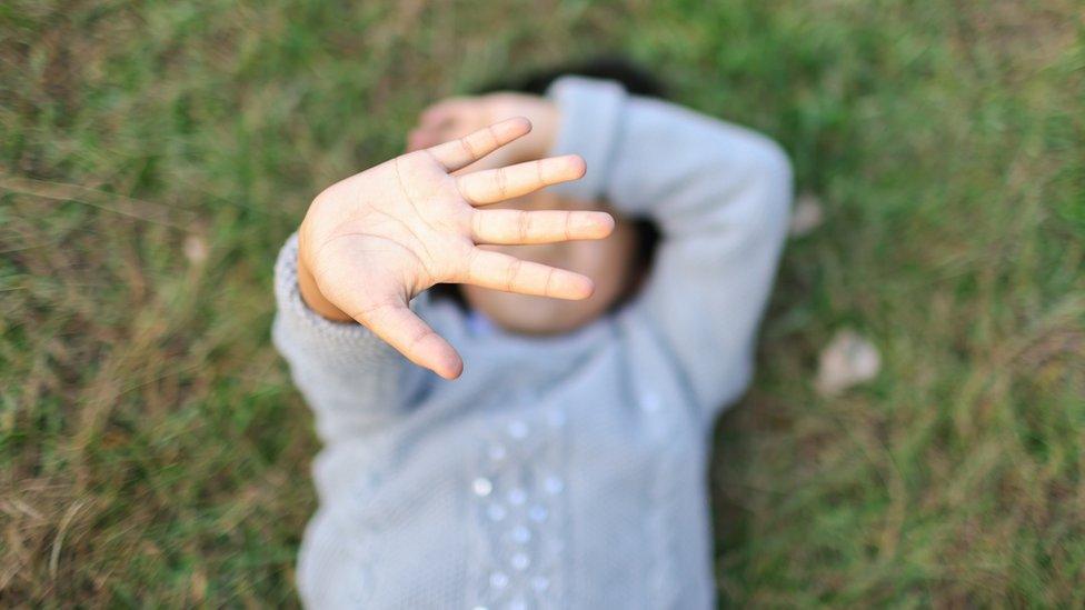 Girl protecting herself with her hand