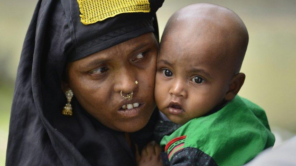 A woman with her baby waits in queue to verify her name on National Register of Citizens draft in Assam on 30 July 2018.