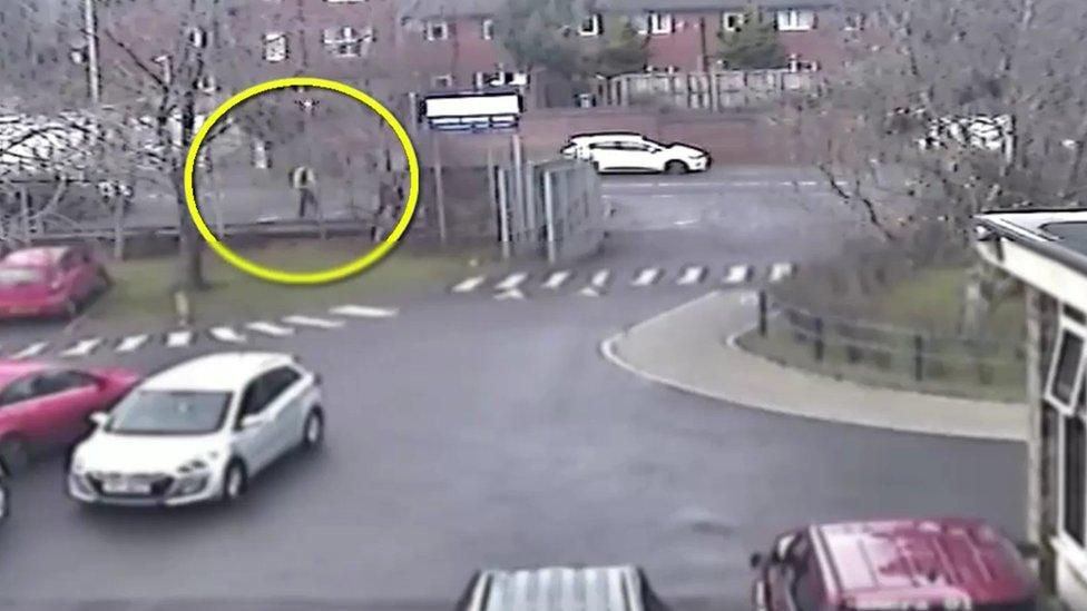 Police CCTV footage of suspected gunman walking towards crime scene in west Belfast