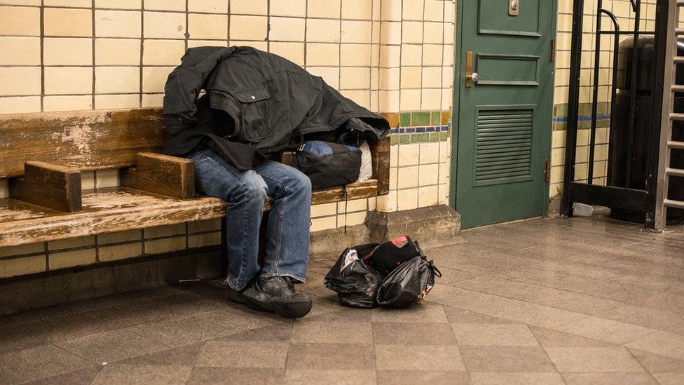 Homeless man sitting on a bench