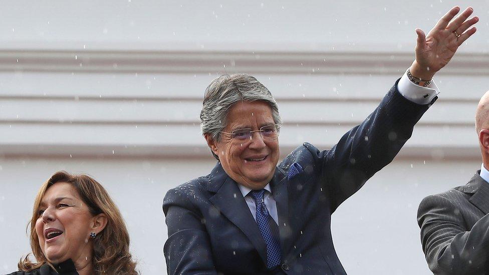 Guillermo Lasso and his wife wave at supporters after addressing the impeachment trial