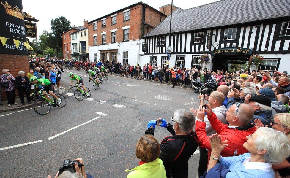 Spectators cheer on the riders as they pass through Southwell, Nottinghamshire, on 6 September 2017