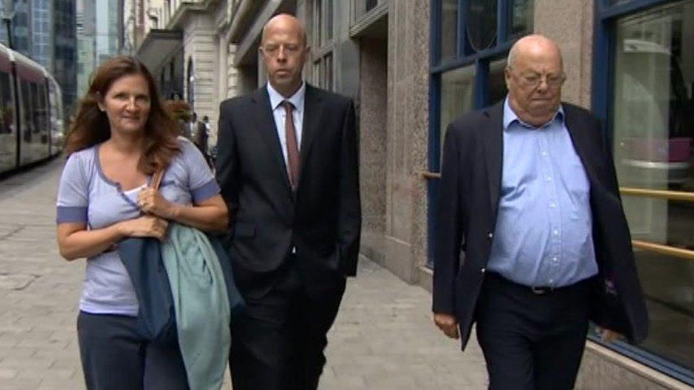 Three people walking in the street