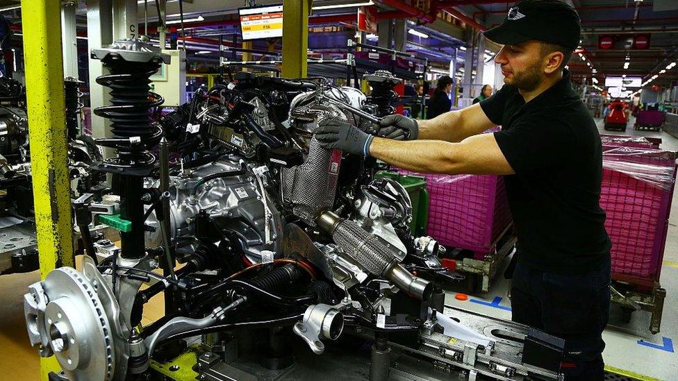 Wide shot of car production worker