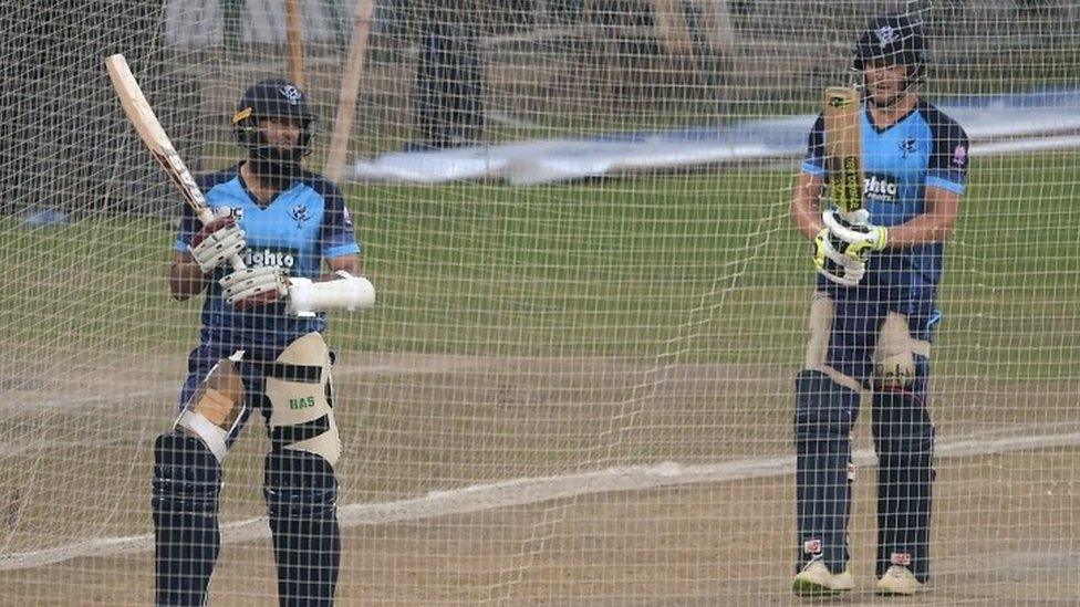 International World XI cricketers Hashim Amla (L) and David Miller prepare to bat during a practice session at the Gaddafi Cricket Stadium in Lahore on September 11, 2017.