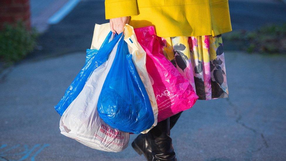 Woman carrying plastic bags