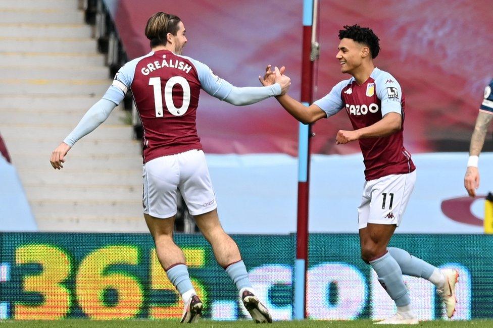 gambling advertising seen on pitchside hoarding behind Aston Villa players