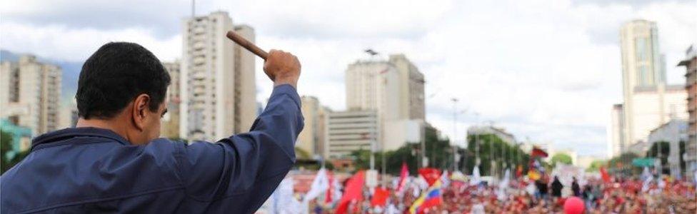 A handout photo made available by the Miraflores Press Office shows Venezuelan President Nicolas Maduro making a fist during a demonstration of "Chavistas" in Caracas, Venezuela, 01 May 2017