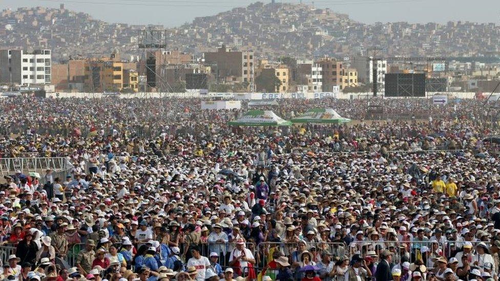 The crowd looks on as Pope Francis arrives to lead a mass at the Las Palmas airbase in Lima, Peru, January 21, 2018.