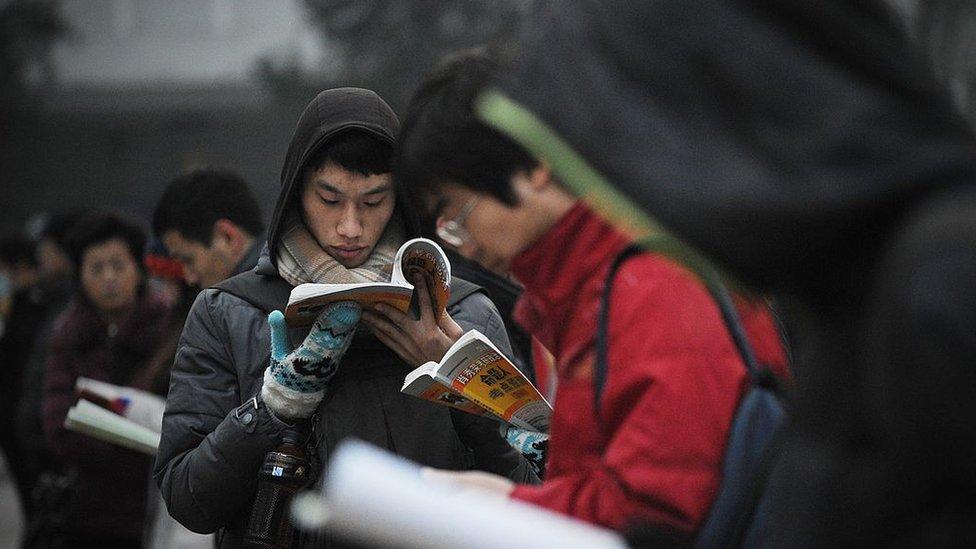 Students read before sitting the National Entrance Examination for Postgraduate (NEEP) at a university in Beijing on January 4, 2014.