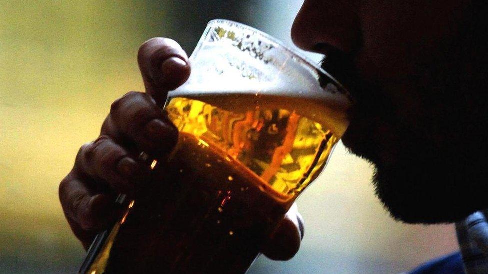 Man drinking a pint of lager