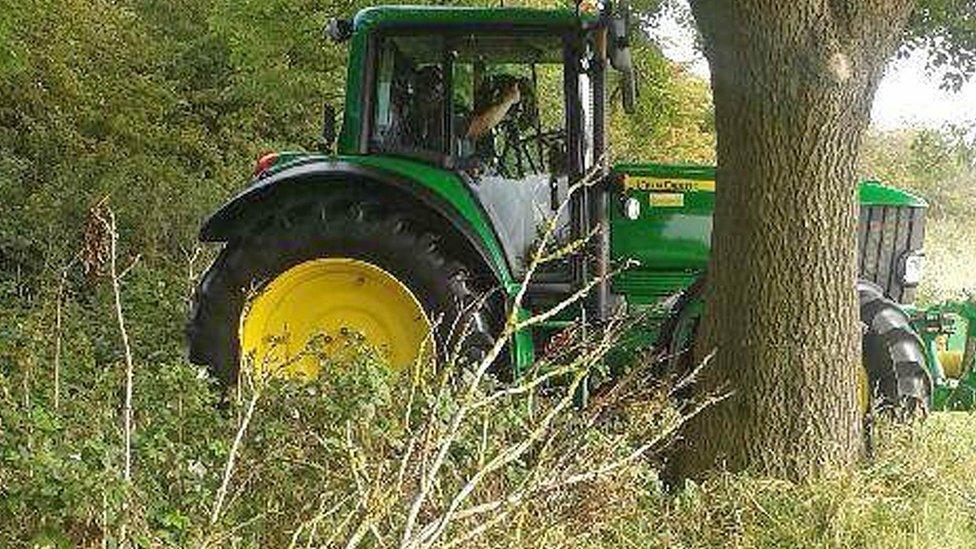 Police officer with speed camera in a tractor